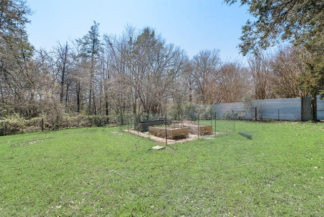 view of yard with fence and a garden