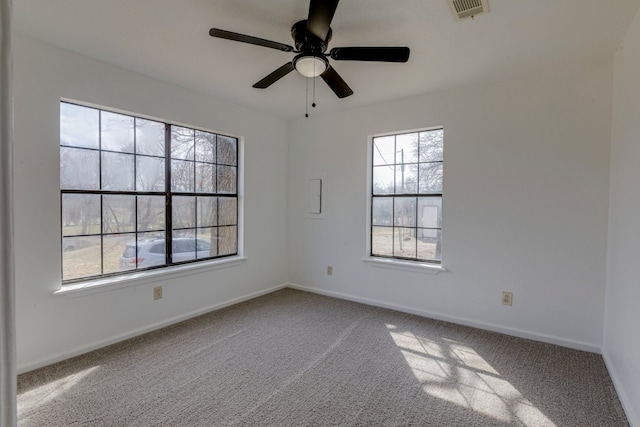 spare room with visible vents, ceiling fan, baseboards, and carpet floors