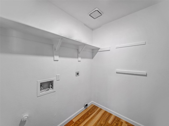 washroom featuring baseboards, light wood-type flooring, laundry area, hookup for a washing machine, and hookup for an electric dryer