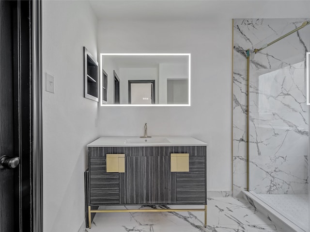 full bath featuring a marble finish shower, marble finish floor, and vanity