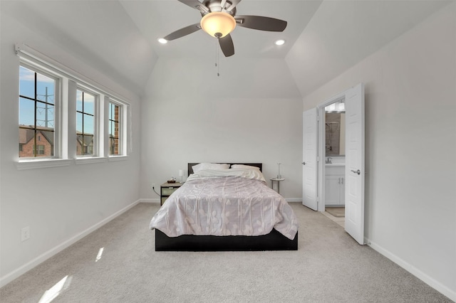 bedroom featuring light carpet, baseboards, and vaulted ceiling