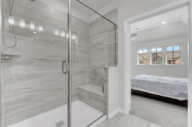 ensuite bathroom with visible vents, baseboards, a stall shower, marble finish floor, and ensuite bath