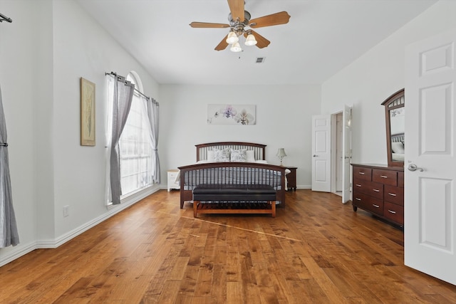 bedroom featuring visible vents, baseboards, and hardwood / wood-style floors