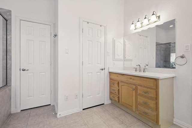 full bathroom with tile patterned floors, walk in shower, and vanity