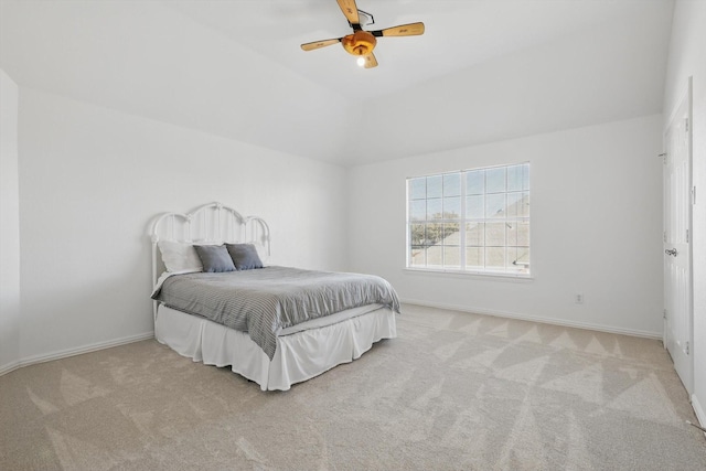 carpeted bedroom featuring baseboards, lofted ceiling, and ceiling fan