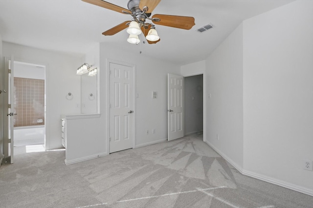 unfurnished bedroom with visible vents, connected bathroom, ceiling fan, baseboards, and carpet floors