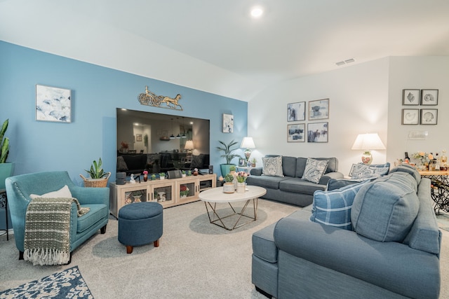 living room with vaulted ceiling, carpet, and visible vents