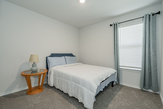 carpeted bedroom with baseboards