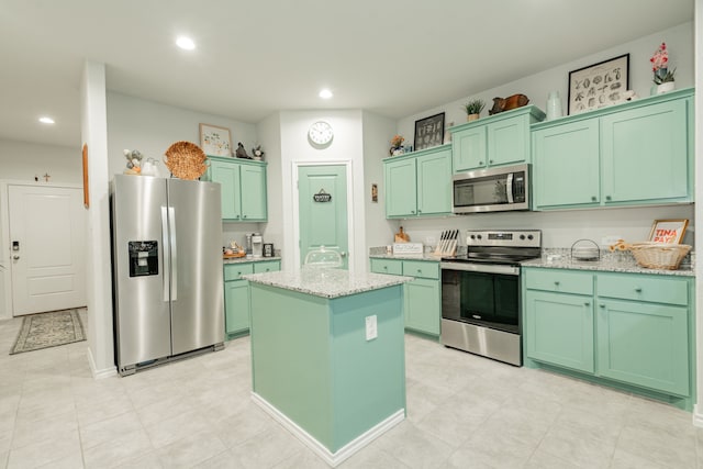 kitchen with green cabinets, recessed lighting, a kitchen island, and stainless steel appliances