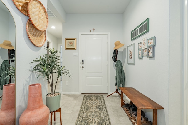 foyer entrance with light tile patterned flooring and baseboards