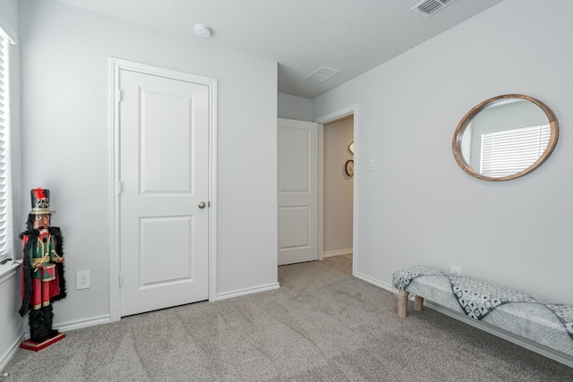 interior space with visible vents, baseboards, and carpet floors