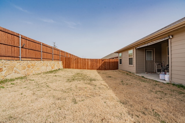 view of yard featuring a patio area and a fenced backyard