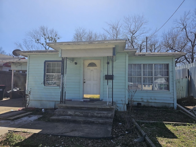 bungalow-style house with crawl space and fence