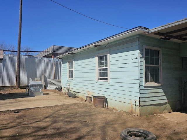 view of home's exterior featuring fence