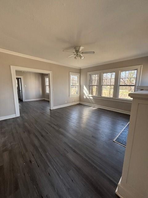 unfurnished living room with baseboards, ornamental molding, and dark wood finished floors