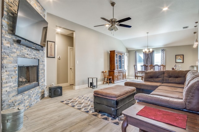 living room featuring visible vents, wood finished floors, lofted ceiling, baseboards, and ceiling fan with notable chandelier