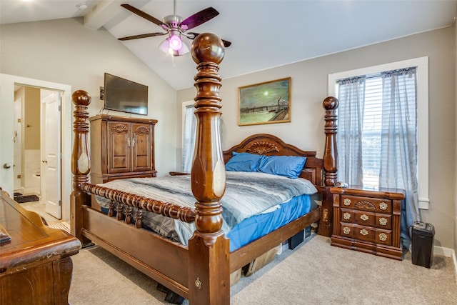 carpeted bedroom featuring ensuite bath, lofted ceiling with beams, and a ceiling fan