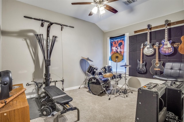 workout room with visible vents, a ceiling fan, carpet, baseboards, and vaulted ceiling