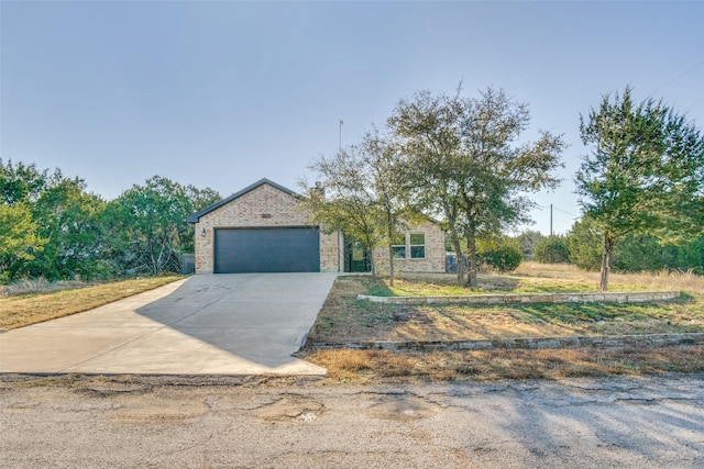 view of front of house featuring concrete driveway and a garage