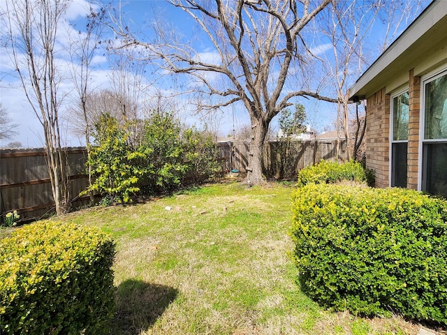 view of yard with a fenced backyard