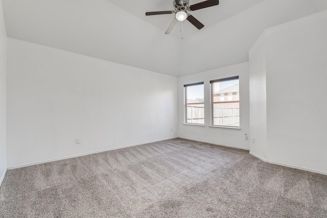 carpeted empty room featuring lofted ceiling, a ceiling fan, and baseboards