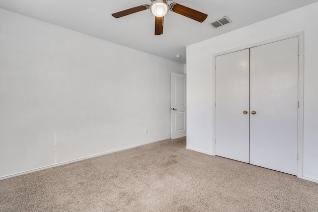 unfurnished bedroom with visible vents, ceiling fan, baseboards, carpet, and a closet