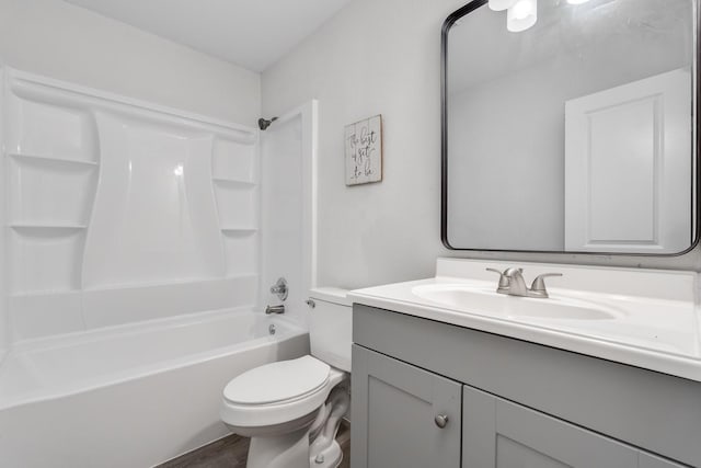 full bath featuring toilet, vanity, bathing tub / shower combination, and wood finished floors