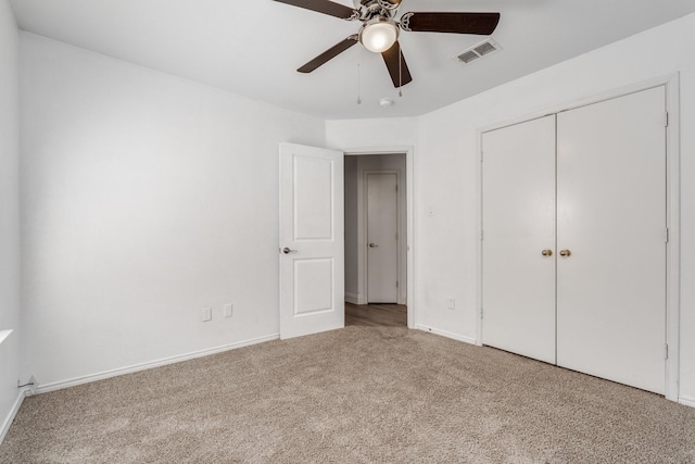 unfurnished bedroom with visible vents, a ceiling fan, a closet, carpet, and baseboards