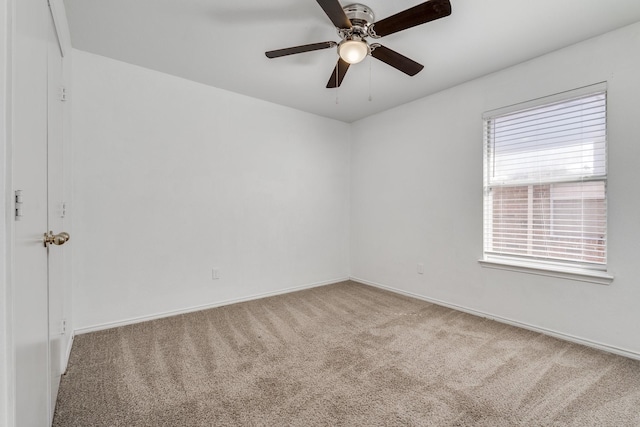 carpeted empty room with baseboards and ceiling fan