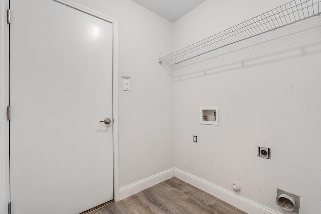 laundry room featuring hookup for a washing machine, hookup for an electric dryer, laundry area, light wood-style floors, and hookup for a gas dryer