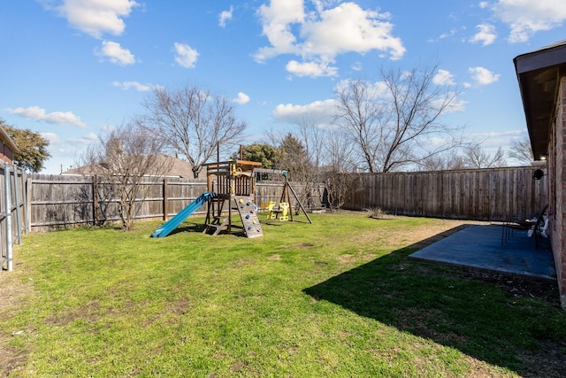 view of yard featuring a patio, a playground, and a fenced backyard