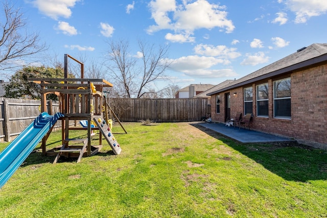 view of yard with a patio, a playground, and a fenced backyard