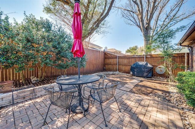 view of patio / terrace featuring a fenced backyard, area for grilling, and outdoor dining space