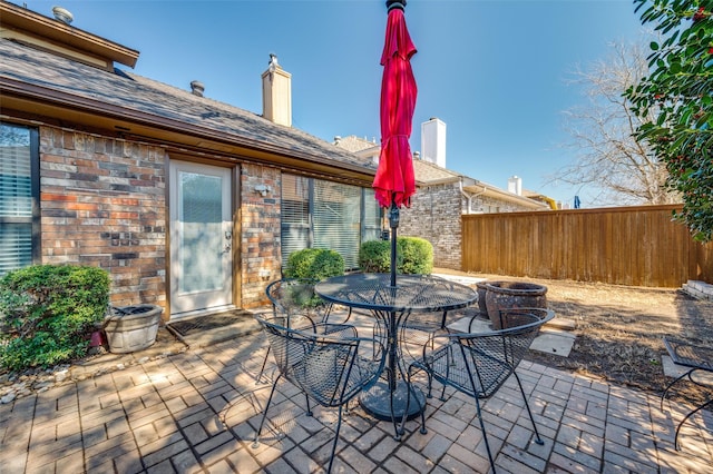 view of patio / terrace with outdoor dining space and fence