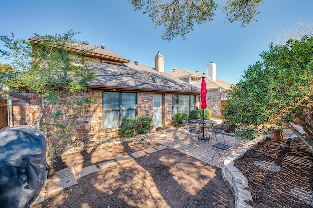 view of patio featuring fence and a grill