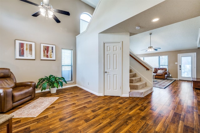 sitting room with stairway, baseboards, ceiling fan, and wood finished floors