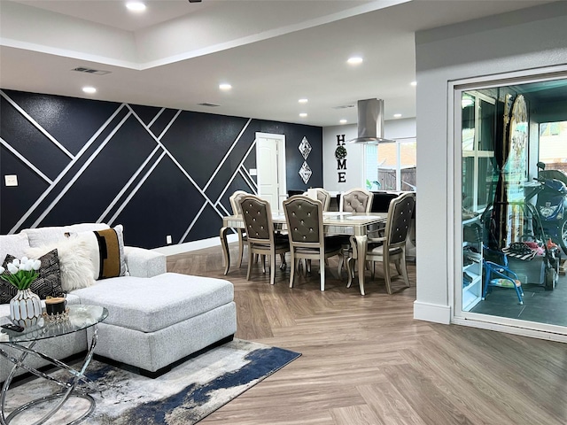 dining area featuring recessed lighting, visible vents, baseboards, and an accent wall