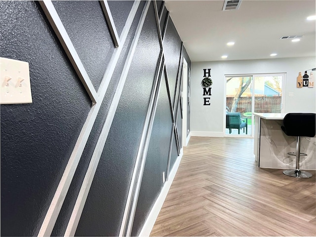 hallway with recessed lighting, visible vents, and baseboards