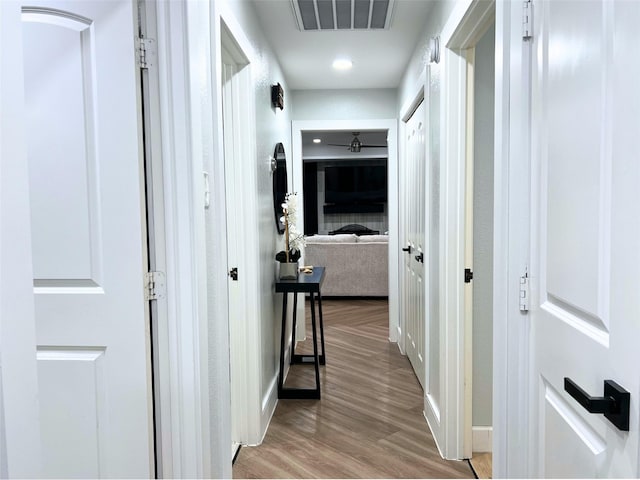 hall featuring visible vents and light wood-type flooring