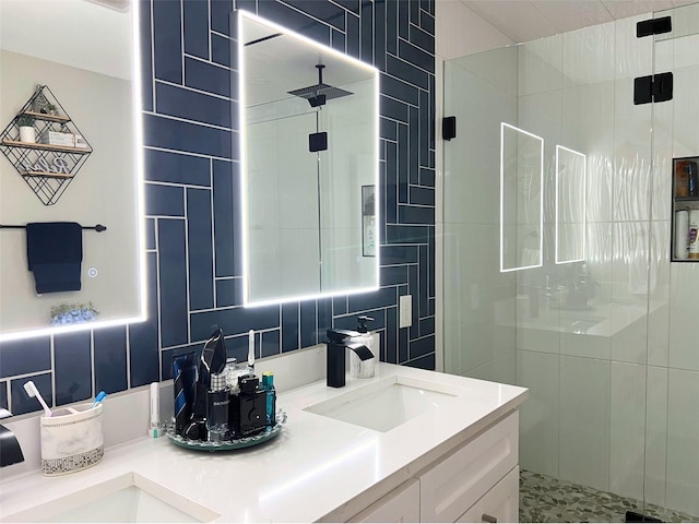 full bath with double vanity, a stall shower, a sink, decorative backsplash, and tile walls