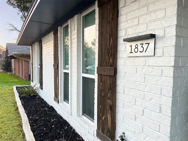 view of side of property featuring brick siding