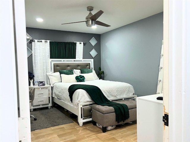 bedroom with ceiling fan and wood finish floors