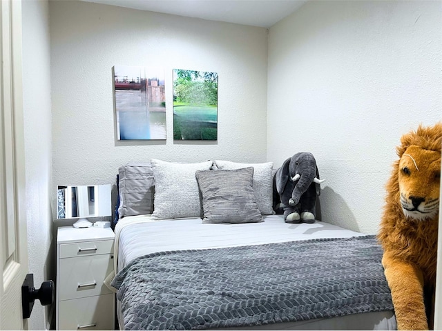 bedroom featuring a textured wall