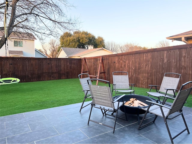 view of patio with a fenced backyard and an outdoor fire pit