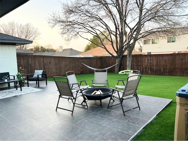 view of patio featuring a fenced backyard and an outdoor fire pit