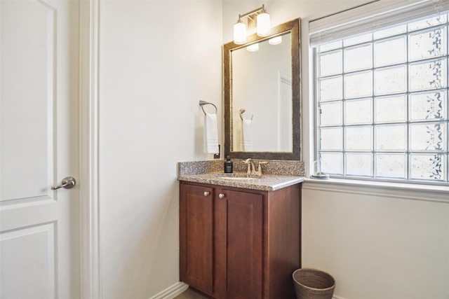 bathroom with baseboards and vanity