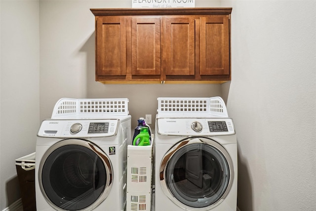 laundry room featuring cabinet space and washing machine and clothes dryer