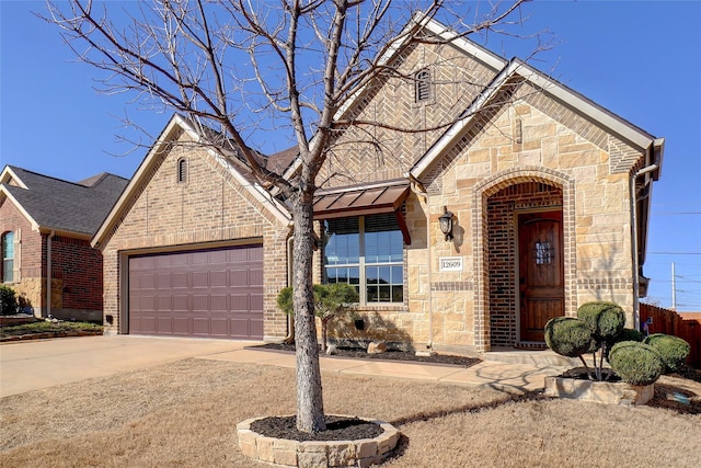 view of front facade with stone siding, brick siding, concrete driveway, and an attached garage