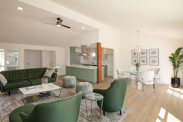 living room with light wood finished floors, a ceiling fan, recessed lighting, and lofted ceiling