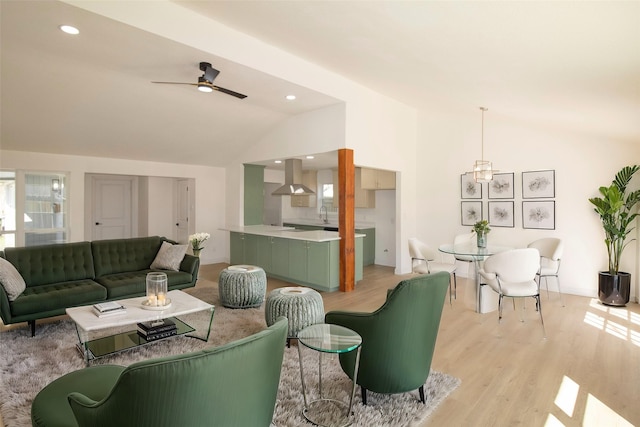 living room featuring recessed lighting, a ceiling fan, light wood-style floors, and lofted ceiling